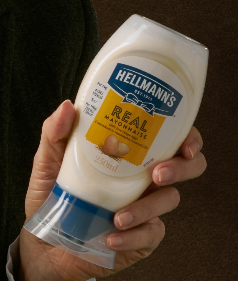 Image of a hand holding a bottle of Hellman's Real Mayonnaise